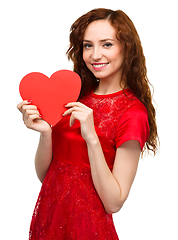 Image showing Young woman holding red heart