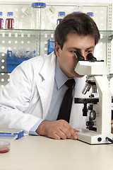 Image showing Scientist looking through microscope