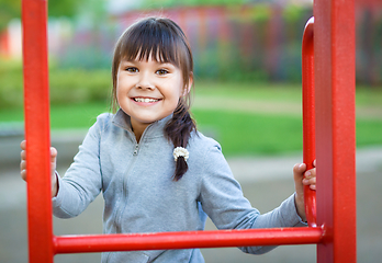 Image showing Cute little girl is playing in playground