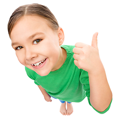 Image showing Little girl is showing thumb up gesture