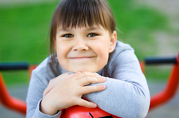 Image showing Cute little girl is playing in playground