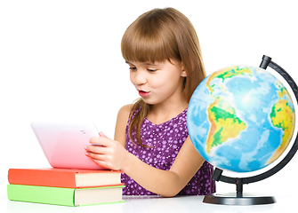 Image showing Young girl is using tablet while studying