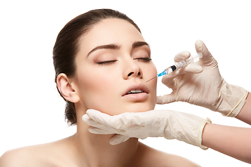 Image showing girl getting face injection isolated on white