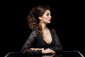 Image showing beautiful young woman with red lips on black