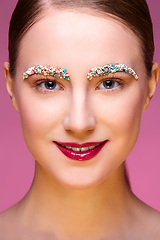 Image showing beautiful girl with candies on pink backgroound