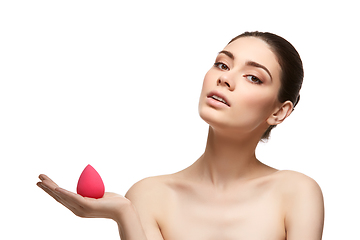 Image showing girl with makeup sponge isolated on white