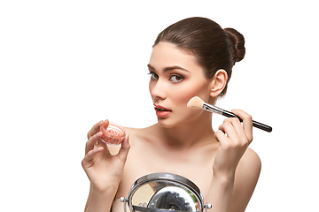 Image showing girl applying blush on face isolated on white