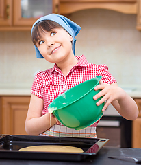 Image showing Girl is cooking in kitchen