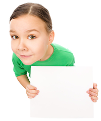 Image showing Happy little girl is holding blank board