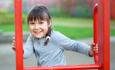 Image showing Cute little girl is playing in playground