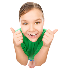 Image showing Little girl is showing thumb up gesture