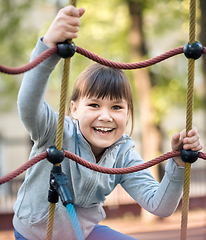 Image showing Cute little girl is playing in playground