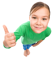 Image showing Little girl is showing thumb up gesture