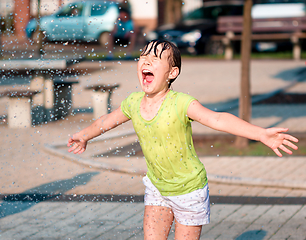 Image showing Girl is running through fountains