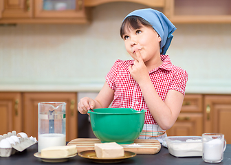 Image showing Girl is cooking in kitchen