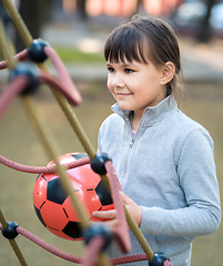 Image showing Cute little girl is playing in playground