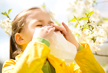 Image showing Little girl is blowing her nose