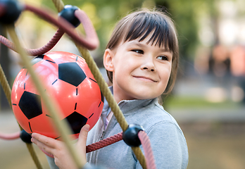 Image showing Cute little girl is playing in playground