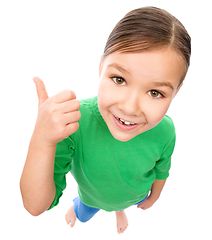 Image showing Little girl is showing thumb up gesture