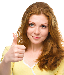 Image showing Woman is showing thumb up gesture