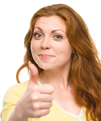 Image showing Woman is showing thumb up gesture