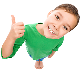 Image showing Little girl is showing thumb up gesture