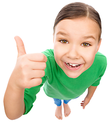 Image showing Little girl is showing thumb up gesture