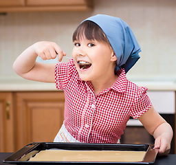 Image showing Girl is cooking in kitchen