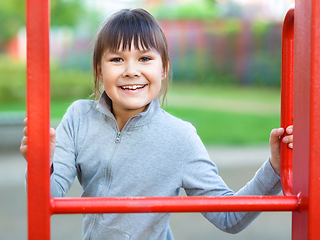 Image showing Cute little girl is playing in playground