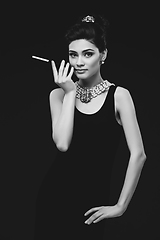 Image showing beautiful young woman in retro style with cigarette