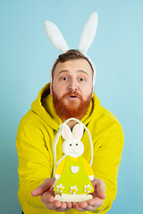 Image showing Easter bunny man with bright emotions on blue studio background