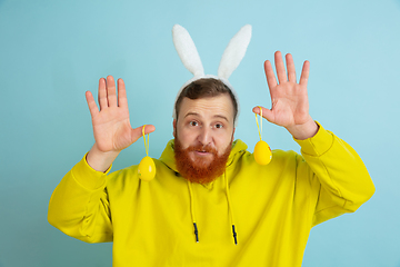 Image showing Easter bunny man with bright emotions on blue studio background