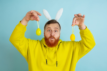 Image showing Easter bunny man with bright emotions on blue studio background