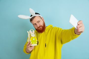 Image showing Easter bunny man with bright emotions on blue studio background