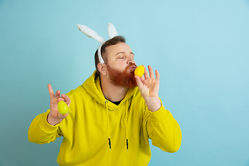 Image showing Easter bunny man with bright emotions on blue studio background