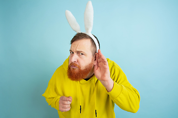 Image showing Easter bunny man with bright emotions on blue studio background