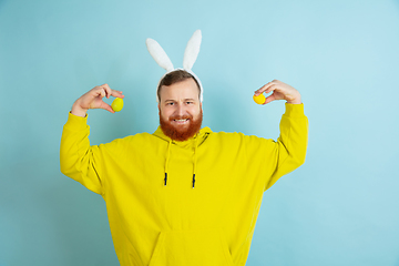 Image showing Easter bunny man with bright emotions on blue studio background