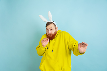 Image showing Easter bunny man with bright emotions on blue studio background