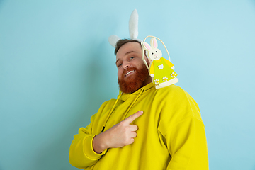 Image showing Easter bunny man with bright emotions on blue studio background