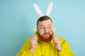 Image showing Easter bunny man with bright emotions on blue studio background