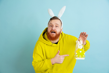 Image showing Easter bunny man with bright emotions on blue studio background