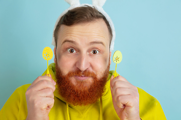 Image showing Easter bunny man with bright emotions on blue studio background