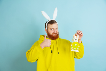 Image showing Easter bunny man with bright emotions on blue studio background