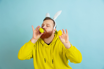 Image showing Easter bunny man with bright emotions on blue studio background