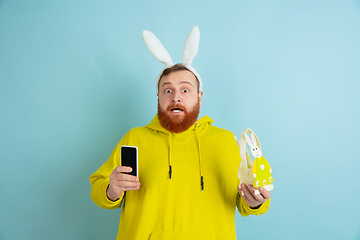 Image showing Easter bunny man with bright emotions on blue studio background