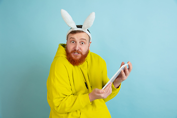 Image showing Easter bunny man with bright emotions on blue studio background