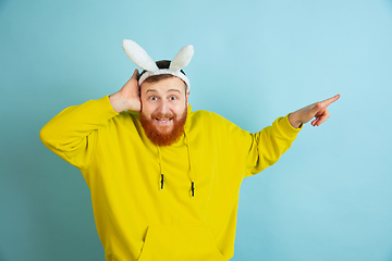 Image showing Easter bunny man with bright emotions on blue studio background