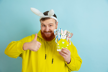 Image showing Easter bunny man with bright emotions on blue studio background