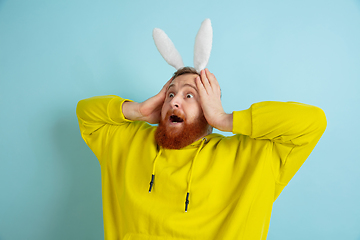 Image showing Easter bunny man with bright emotions on blue studio background