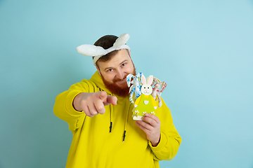 Image showing Easter bunny man with bright emotions on blue studio background